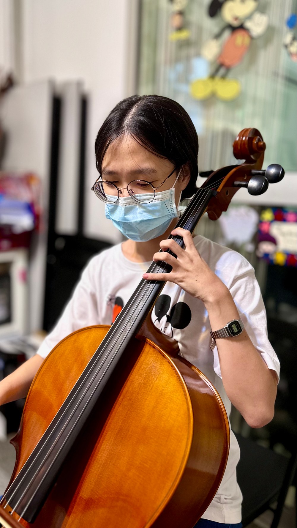 A student practising the cello at the studio